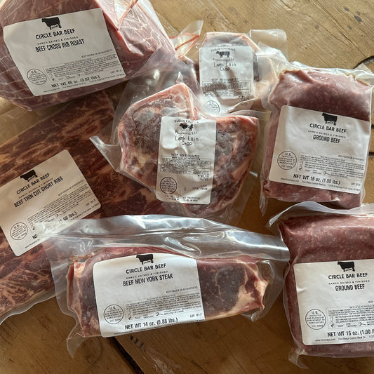 Packages of raw beef with labels on a wooden surface