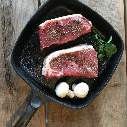 new york steak in a cast iron pan