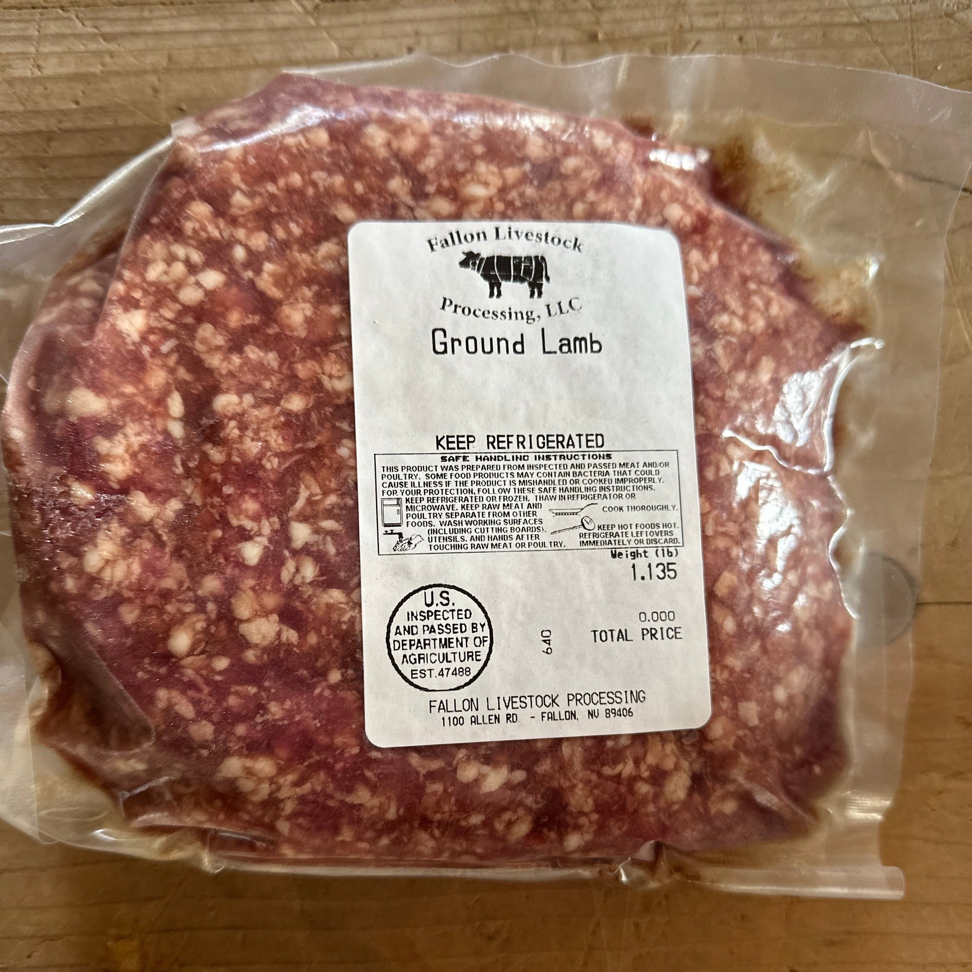 Packaged ground lamb with a label on a wooden surface